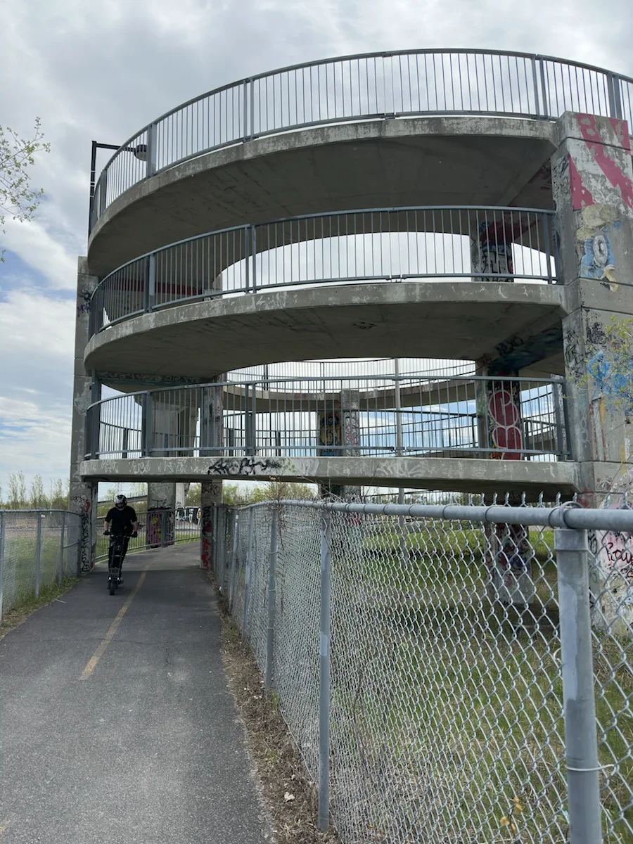 A loaded bicycle below a tall spiral observation structure